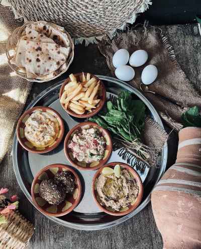 Traditional Egyptian Breakfast with Falafel, Fried Eggs, French Fries and Baladi Bread