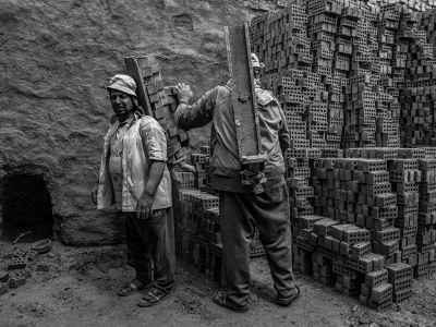 Workers Carrying Bricks at Al-Qanater Al-Khayreya Site