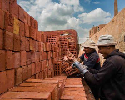 Brick Workers Stacking Red Clay Bricks, Al-Qanater