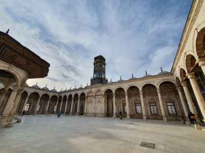 Mosque of Muhammad Ali Courtyard Under a Bright Cloudy Sky