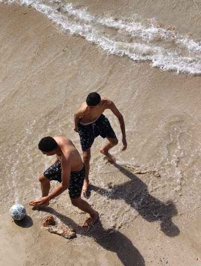 Two Men Playing Football on Alexandria Beach