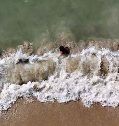 Top View of a Child Facing the Waves in Alexandria