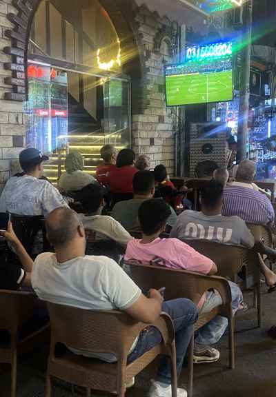 Egyptian Fans Watching Live Football Match at Café
