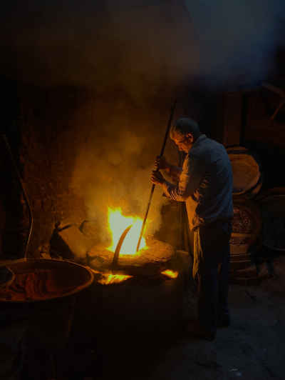 Traditional Craftsman Working Beside a Furnace