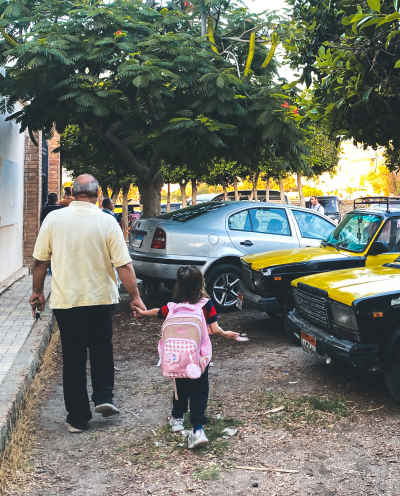 Grandfather Walking Granddaughter to School, Alexandria