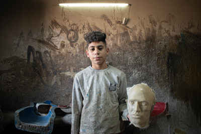 Young Worker with Mannequin Head Mold, Al-Kharaqaniyah