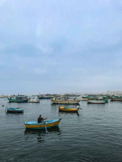 Fisherman Rowing Wooden Boat, Alexandria Harbor Egypt