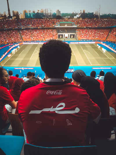 Egyptian Football Fan Watching a Match from the Stadium Stands
