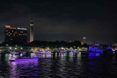 Cairo Tower and Nile River at Night with Boats