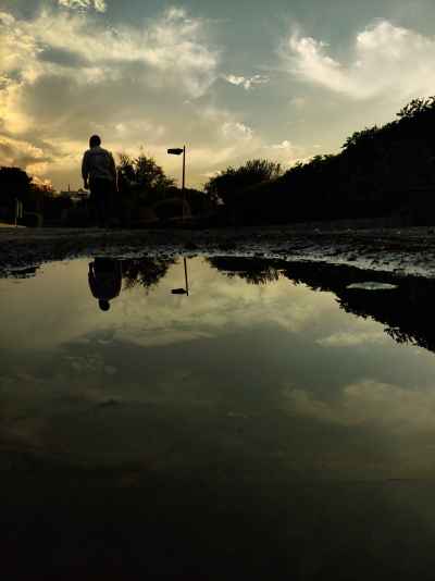 Person Silhouette Reflected in Puddle, Al-Azhar Park Cairo
