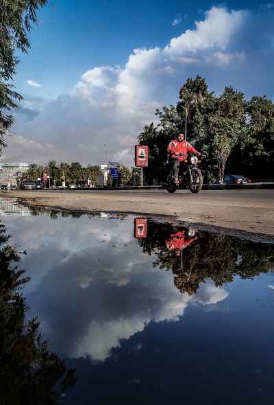 Motorcyclist Reflected in Street Puddle, Downtown Cairo