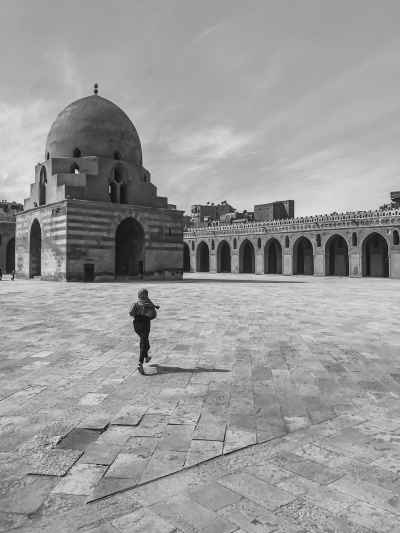 Person Walking in Ibn Tulun Mosque Courtyard, Cairo