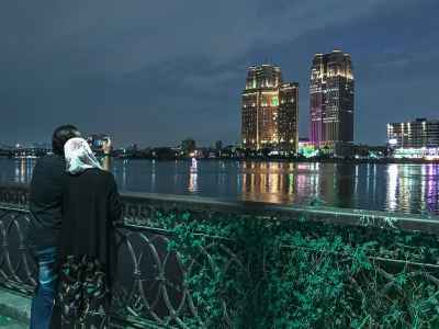 Couple Photographing Nile Corniche Skyline at Night Cairo