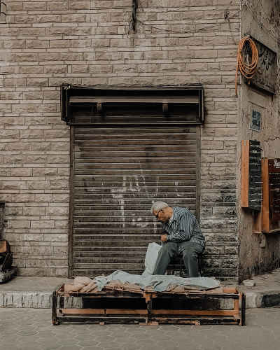 Elderly Street Vendor Selling Baladi Bread, Downtown Cairo