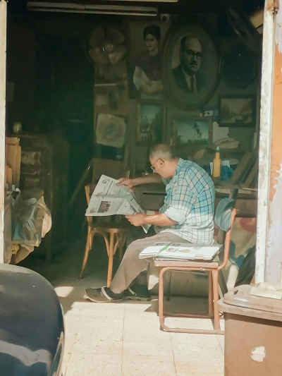 Antique Shop Owner Reading Newspaper, Abdeen Street Cairo