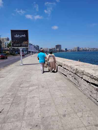 Couple Walking Alexandria Corniche Waterfront, Egypt