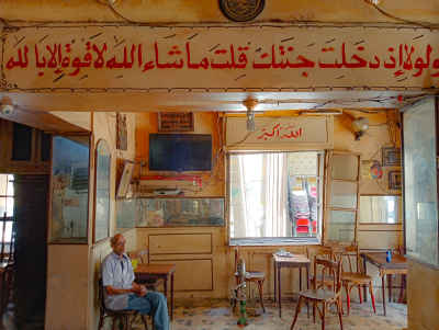 Man Sitting Alone at Sayed Darwish Cafe, Alexandria