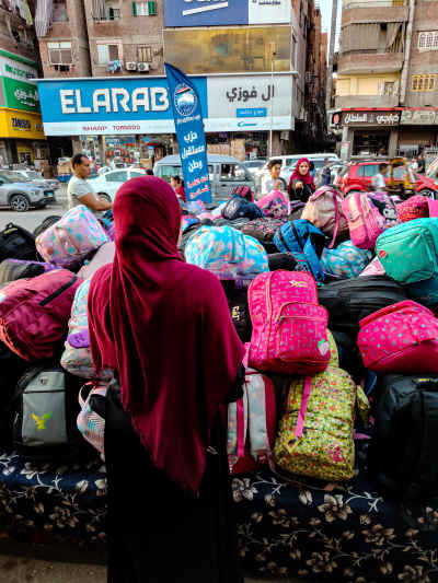 Woman Browsing School Bags at Cairo Street Market