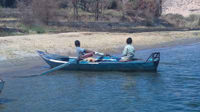 Two Nubian Boys Rowing Wooden Boat on Nile Aswan