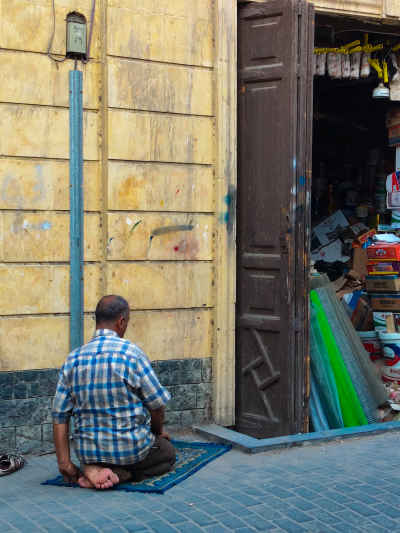Man Praying Outside Shop, Al-Ashraf Street Cairo