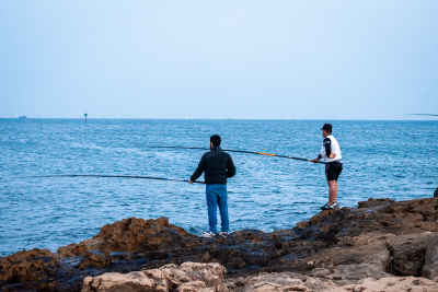 Two Men Fishing from Rocky Shore, Alexandria