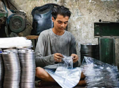 Young Worker Packaging Metal Dishes, Al-Gamaliya Cairo