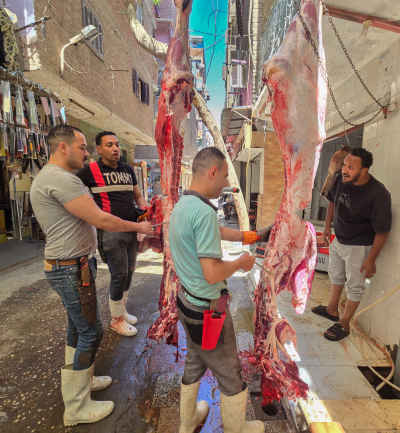 Traditional Butchers (Gazzareen) Working on Hanging Meat in an Alley of Old Maadi, Cairo
