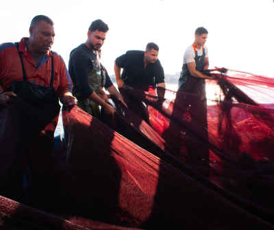 Egyptian Fishermen Hauling Red Fishing Net at Sea