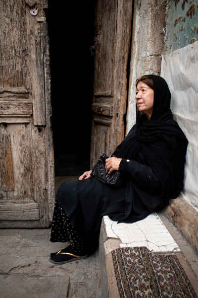 Egyptian Woman Sitting Outside Historic Door, Cairo