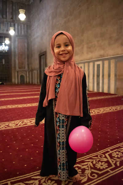 Smiling Girl with Balloon Inside the Mosque on Eid