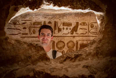 Foreign Tourist at Abu Simbel Temple Hieroglyphics Wall