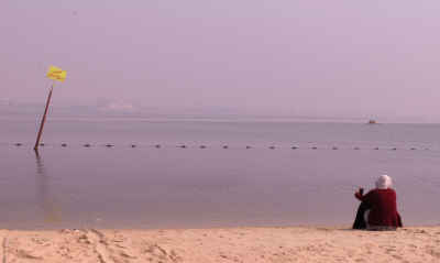 Woman Sitting on Ismailia Beach, Egypt