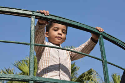 Child Playing on Green Metal Structure, Fish Garden Giza