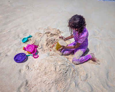 Child Building Sandcastle on Beach, Al Alamein