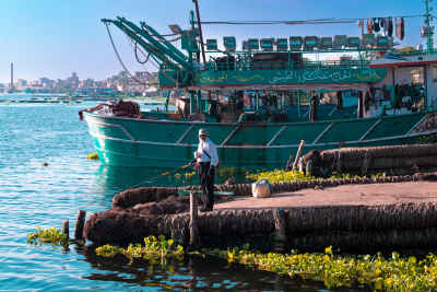 Fisherman on Dock with Fishing Boat, Rashid