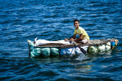 Young Man on Makeshift Raft, Nile River Aswan