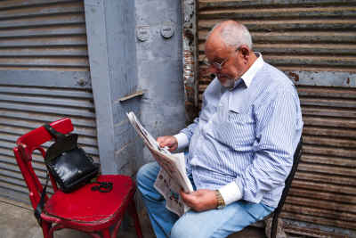 Man Reading Newspaper, Al-Gamaliya Street, Cairo