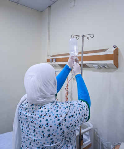 Nurse Preparing IV Drip, Hospital Room Cairo