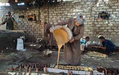 Pouring Molasses for Traditional Jallab Production
