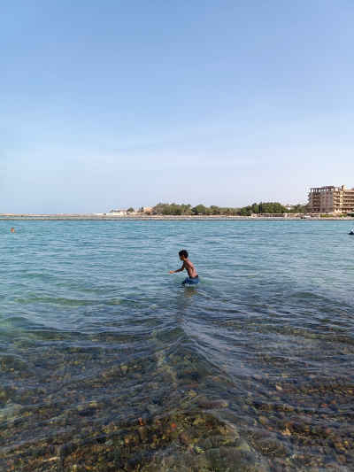 Child Playing in Red Sea Shallow Water, Hurghada