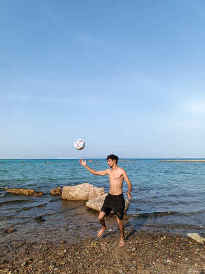 Young Man Playing Football on Red Sea Shore Hurghada