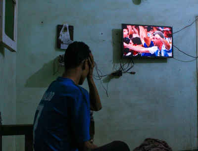 Football Fan Watching Match Alone at Home, Qena