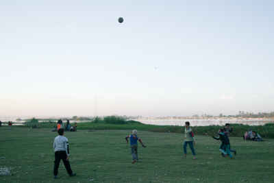 Children Playing Football on an Open Field in Qena, Egypt