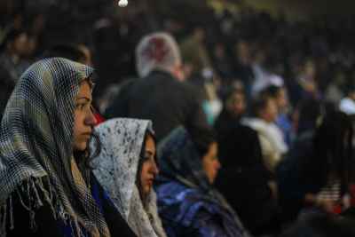 A Young Woman in Prayer on a Feast Day in Church