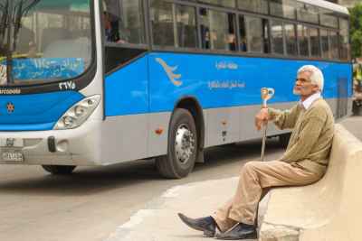 Abbassia Cairo Bus Stop Elderly Man Sitting with Cane