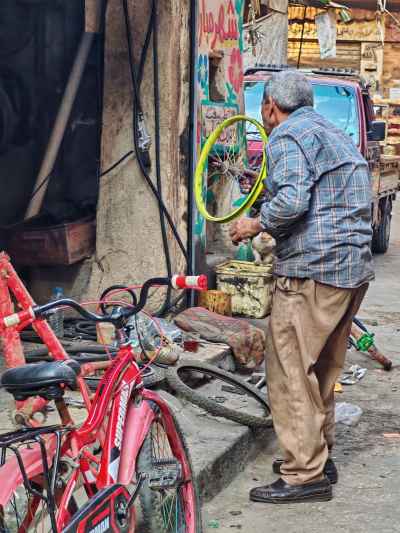 Traditional Egyptian Bicycle Repairman – “El Agalaty” in Historic Cairo