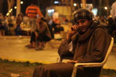 Al Sayyida Nafisa Mawlid Cairo Nights Man Sitting in Public Space