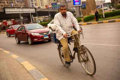 Bearded Man Riding a Bicycle in Cairo