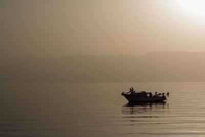 Boat at Sunset on Calm Sea