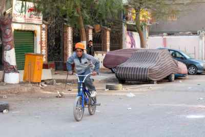 Egyptian Boy Riding Bicycle on Cairo Street